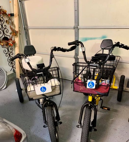 Two Liberty Trikes with handicap badges, not ADA approved